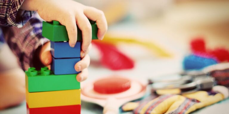 A vibrant assortment of age-appropriate toys for children displayed on ChildrenSale.com, emphasizing the importance of fostering creativity and learning through play.